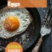 A vibrant photo showing a frying pan with a perfectly fried egg, with a set, firm white and partially runny yolk, and a spatula nearby. The background is a dark, black wooden texture surface. This image demonstrates egg frying techniques.