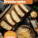 Top-down view of equipment and ingredients needed for making breadcrumbs. Includes a bread board with slices of bread, a bread knife, a baking tray with bread slices, a box grater, and a bowl with breadcrumbs. The background is a dark, black wooden texture surface.