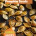 A vibrant photo showing golden, roasted pumpkin seeds on a baking tray, sprinkled with seasoning. The background is a dark, black wooden texture surface. This image demonstrates pumpkin seed roasting techniques.